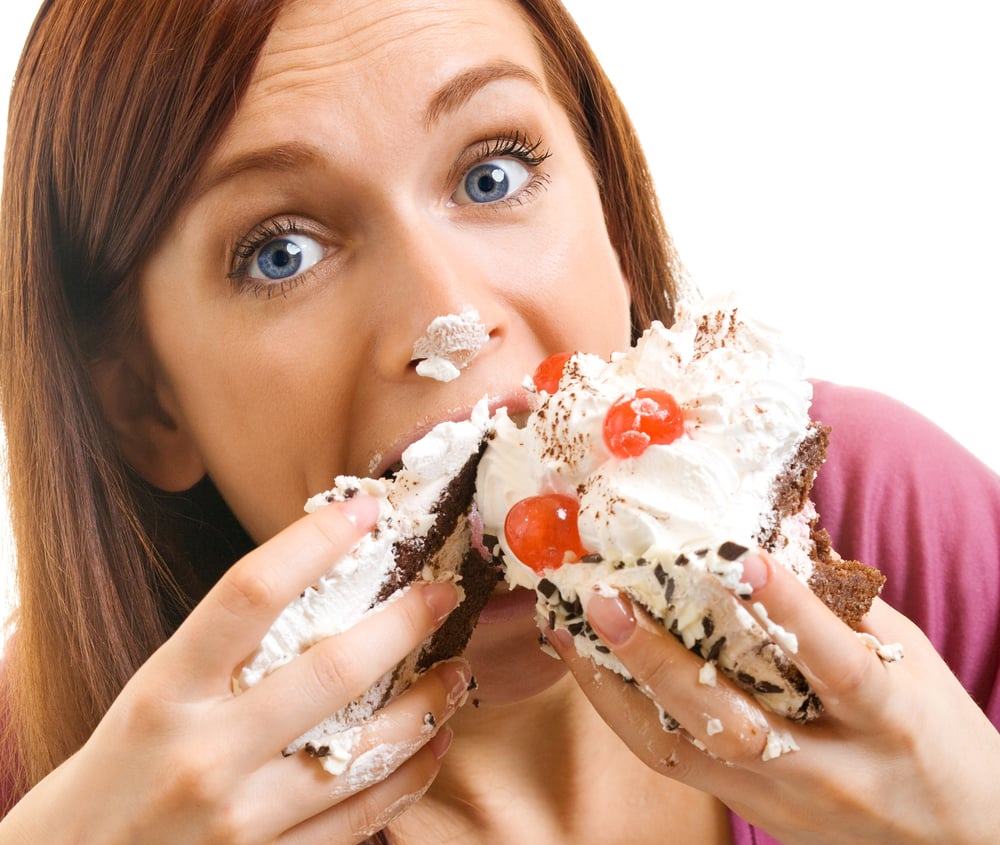 Woman Eating Cake with Two Hands