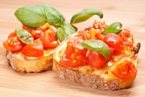 bruschette italian appetizer fresh homemade crispy called bruschetta topped tomato garlic basil wooden board 31187345
